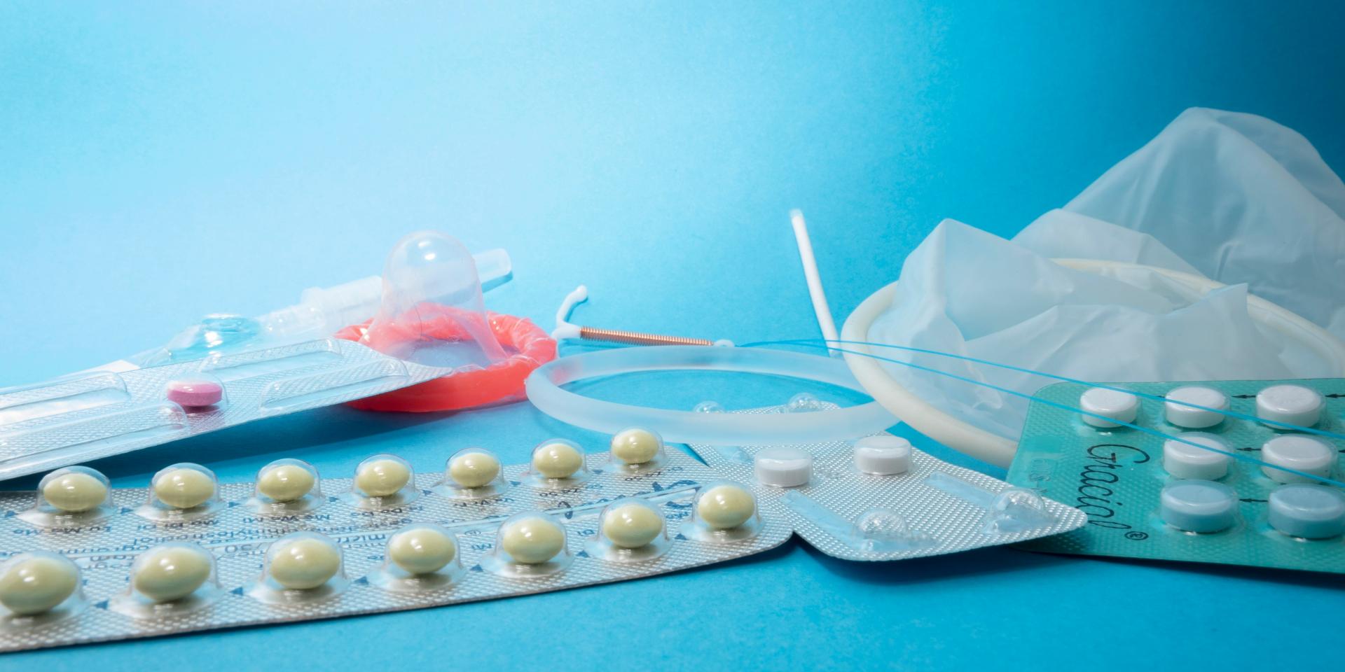 Various contraceptives against bright blue background