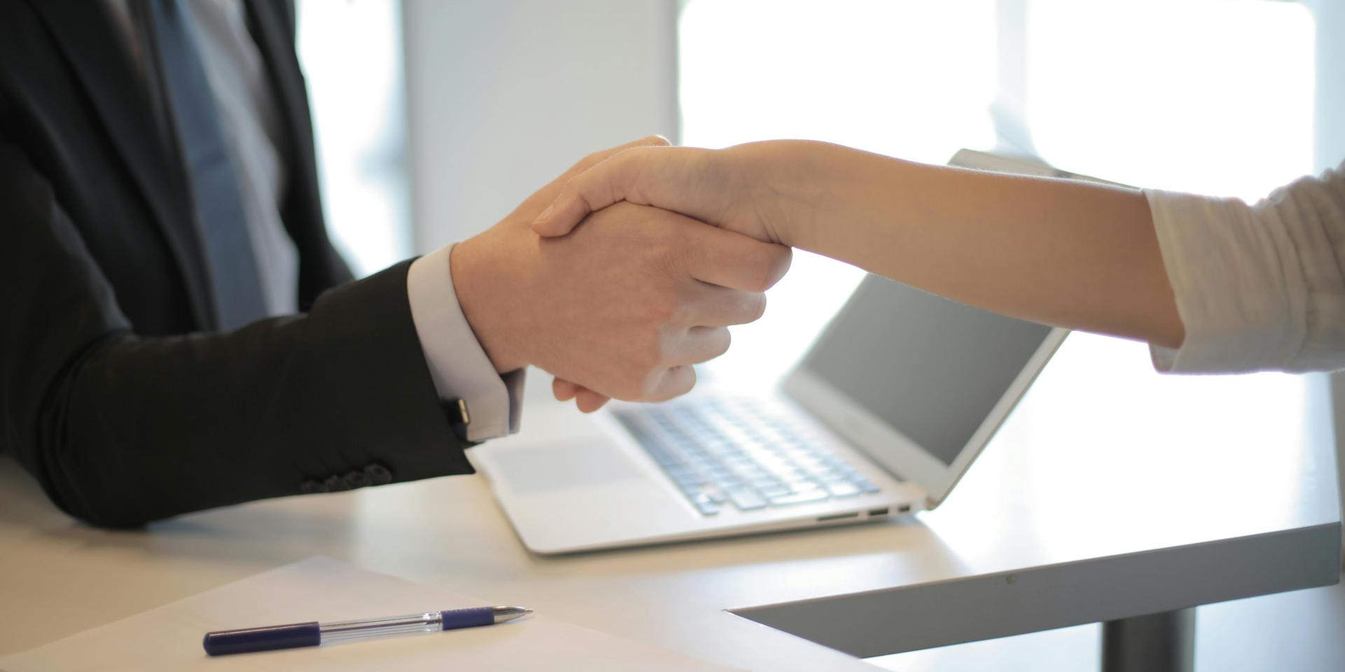 Two people shake hands