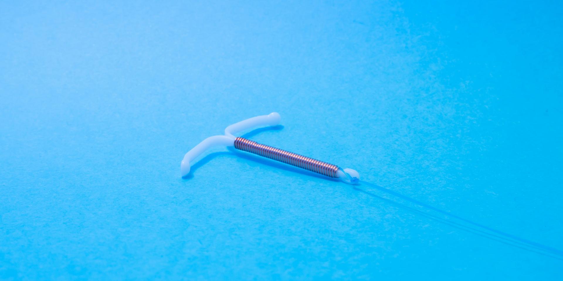 Copper IUD with a bright blue background