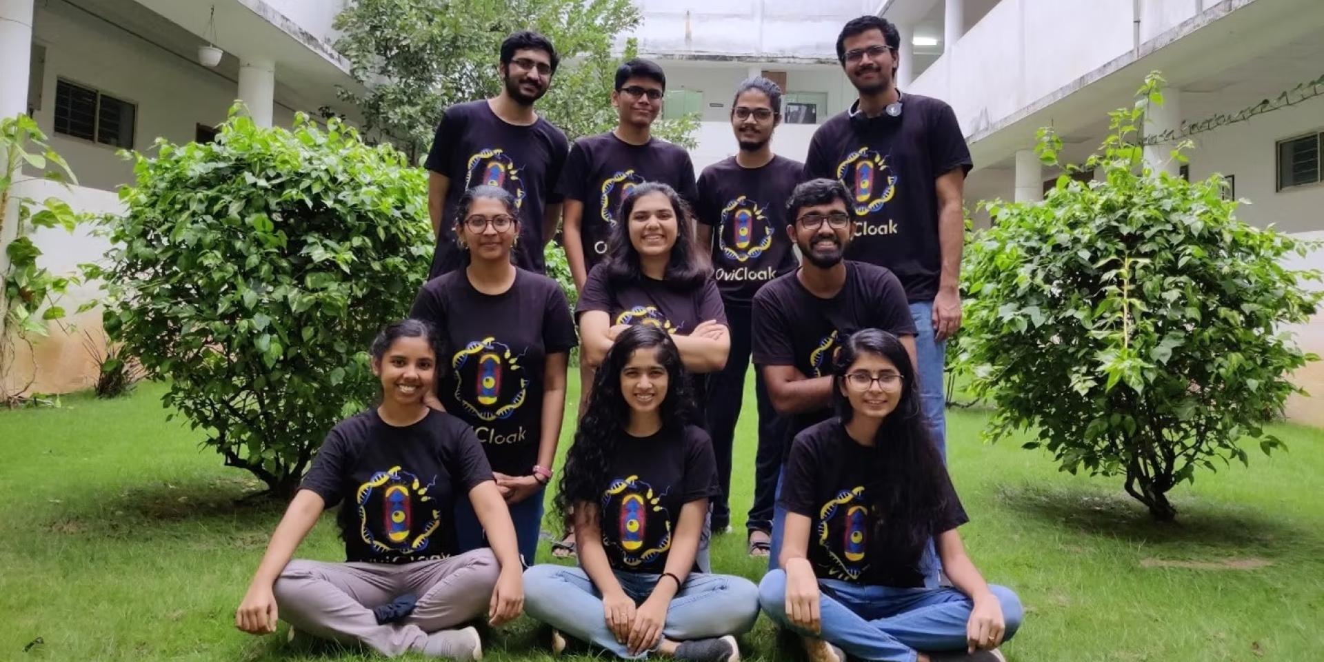 Group of 10 students pose in matching shirts outdoors