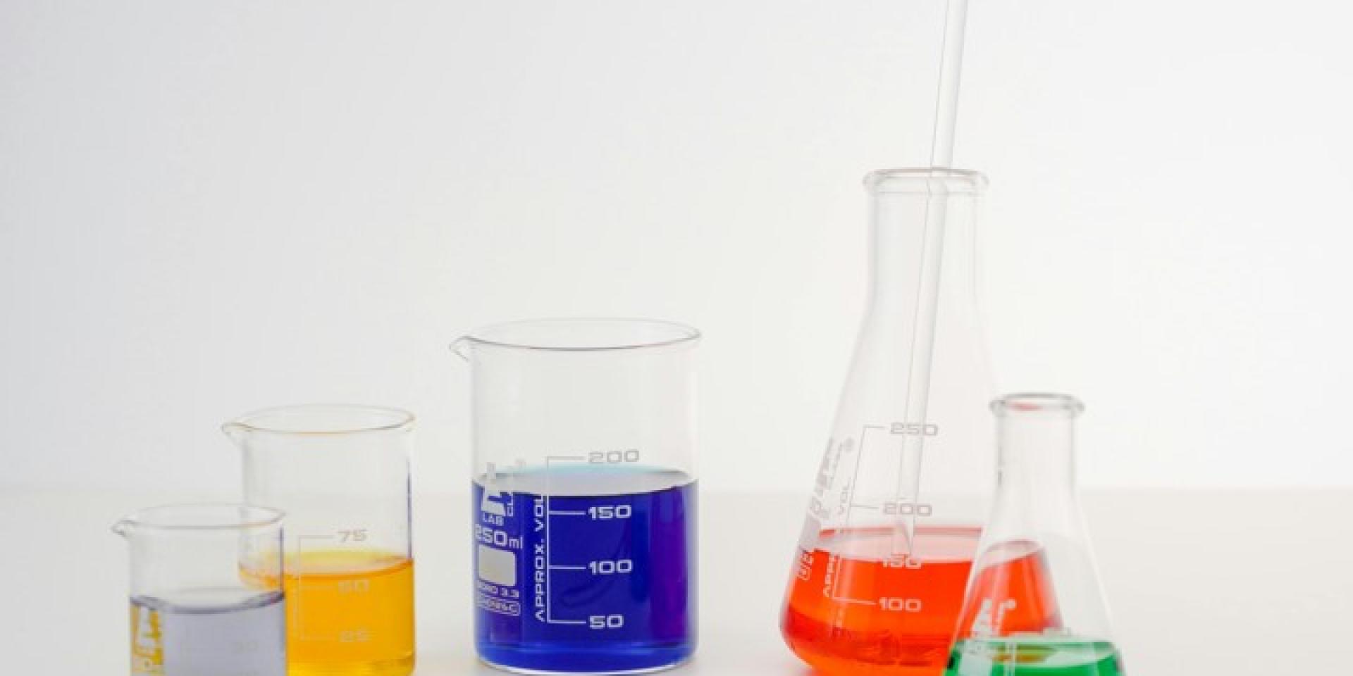 Clear containers filled with liquids of various bright colors