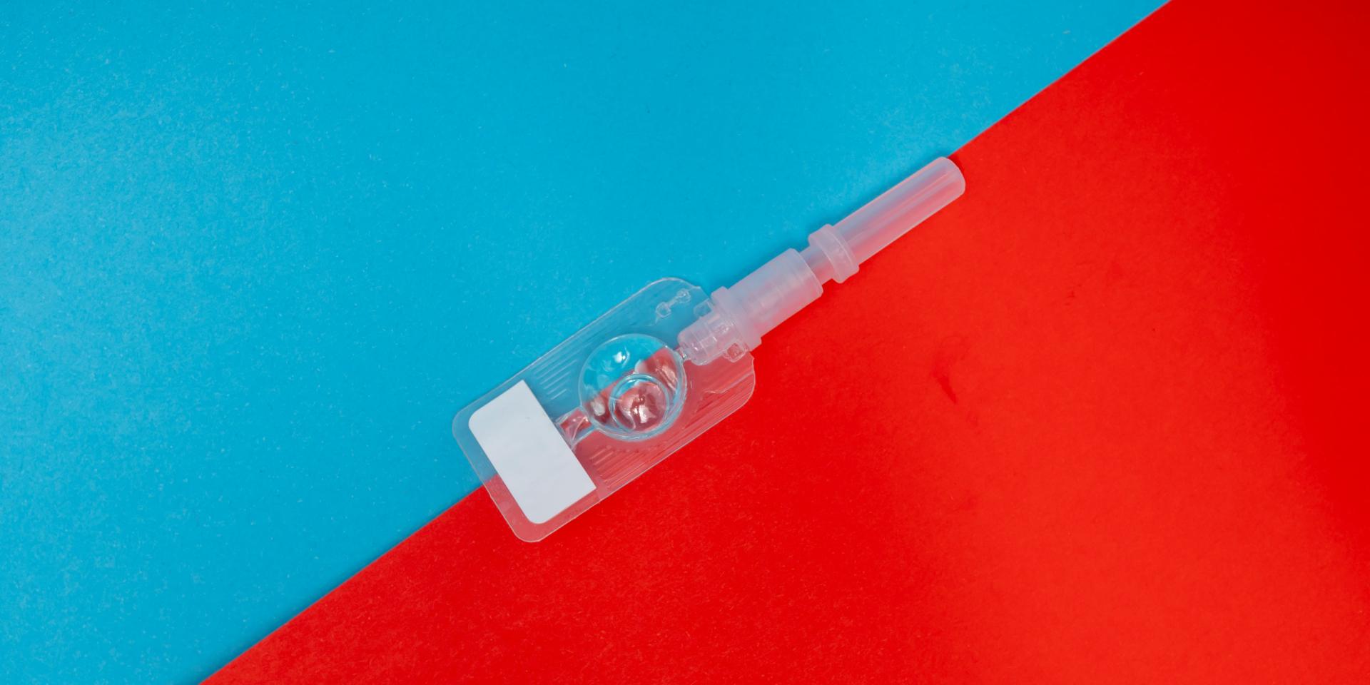 A sefl-injectable contraceptive on a bright blue and red background