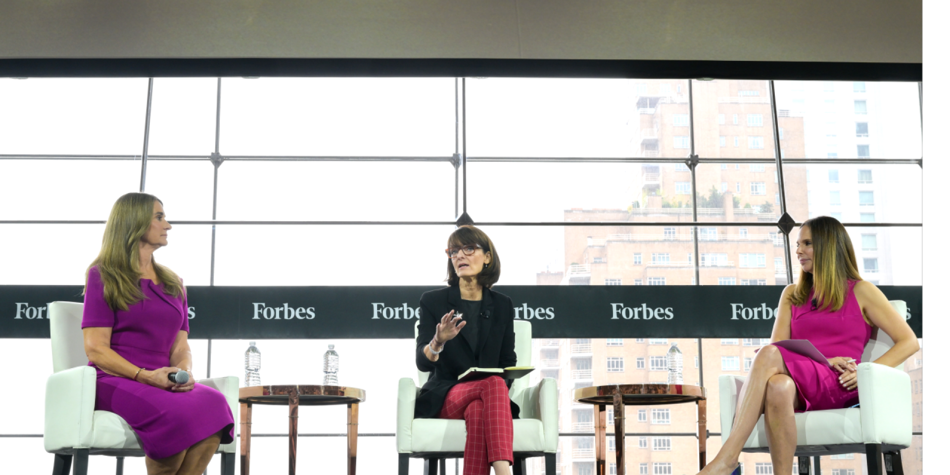 Three women, including Melinda Gates, sitting and having a discussion with 