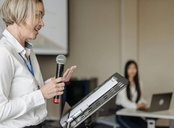 Person at music stand holds microphone