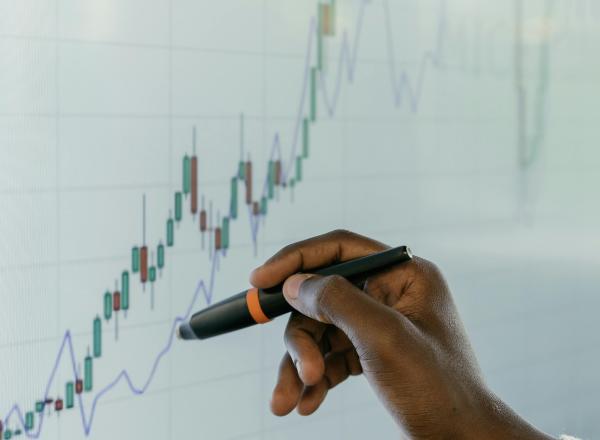 A person plots a graph on a whiteboard