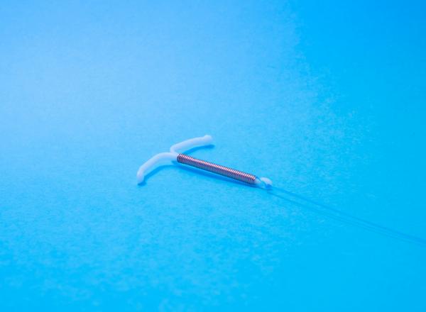 Copper IUD with a bright blue background