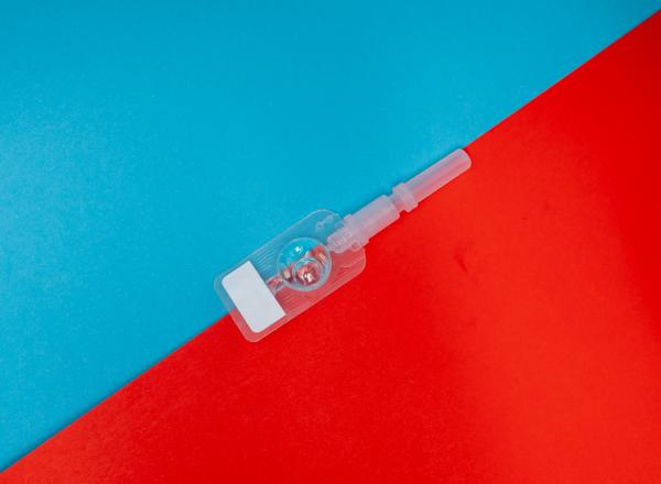 A sefl-injectable contraceptive on a bright blue and red background