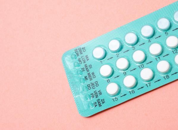 Contraceptive pill pack on a pink background