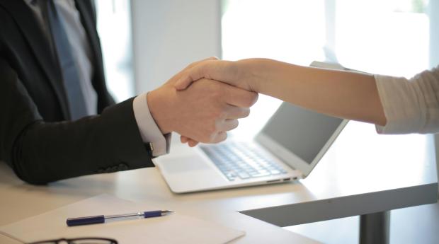 Two people shake hands